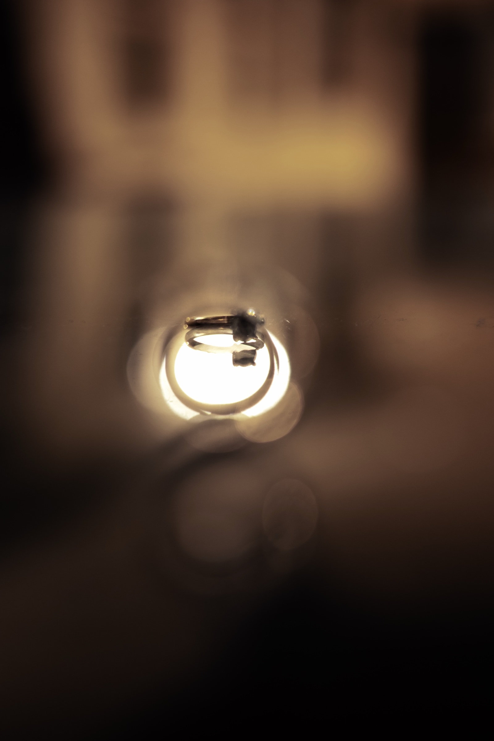 The couple's wedding rings in candlelight