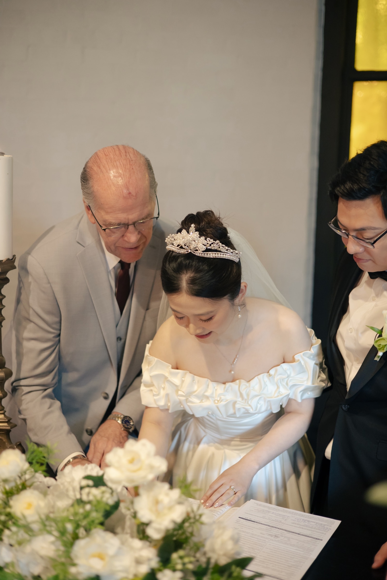 Bride and groom exchanging vows at the candlelit chapel altar