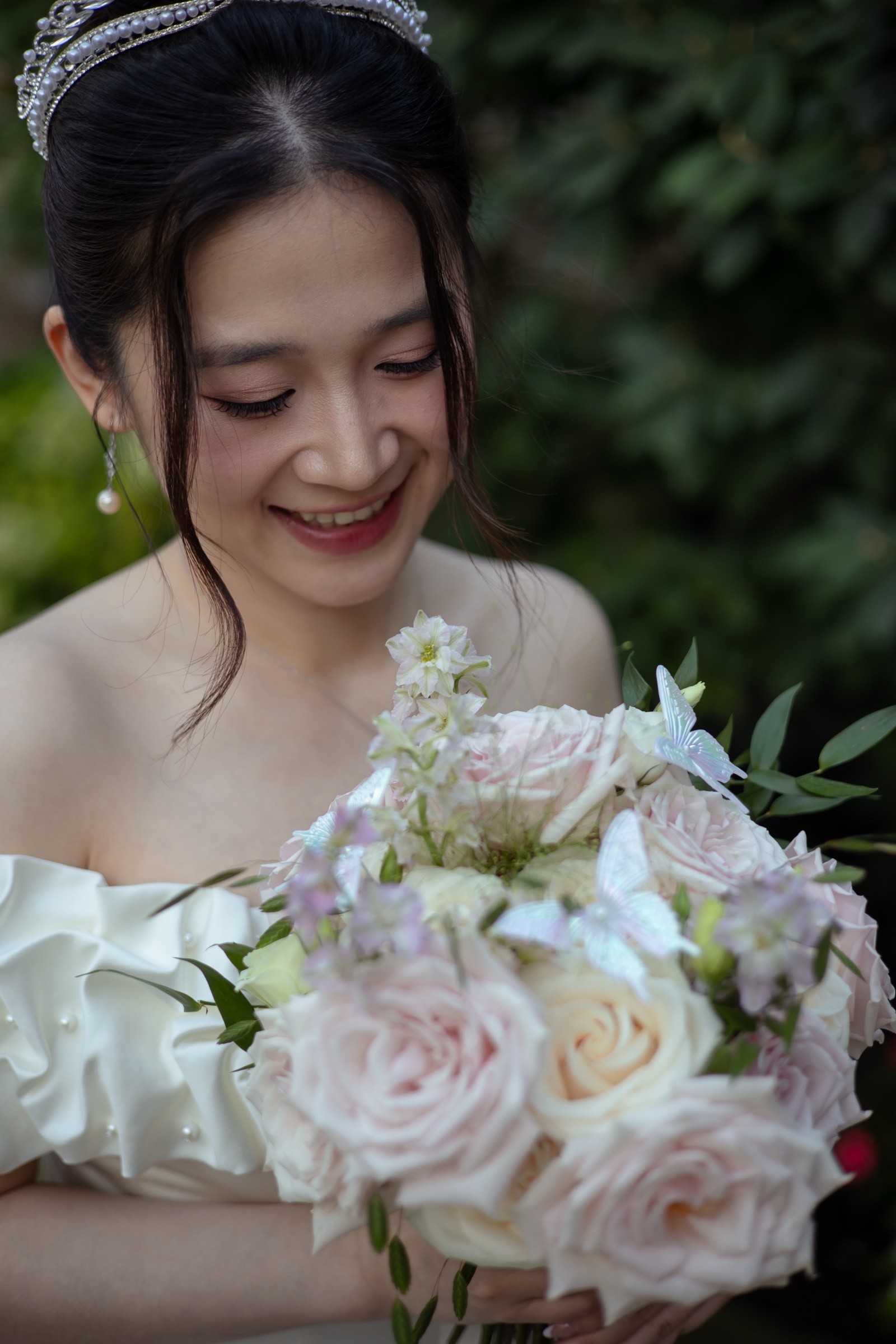 The bride smiling with her bouquet