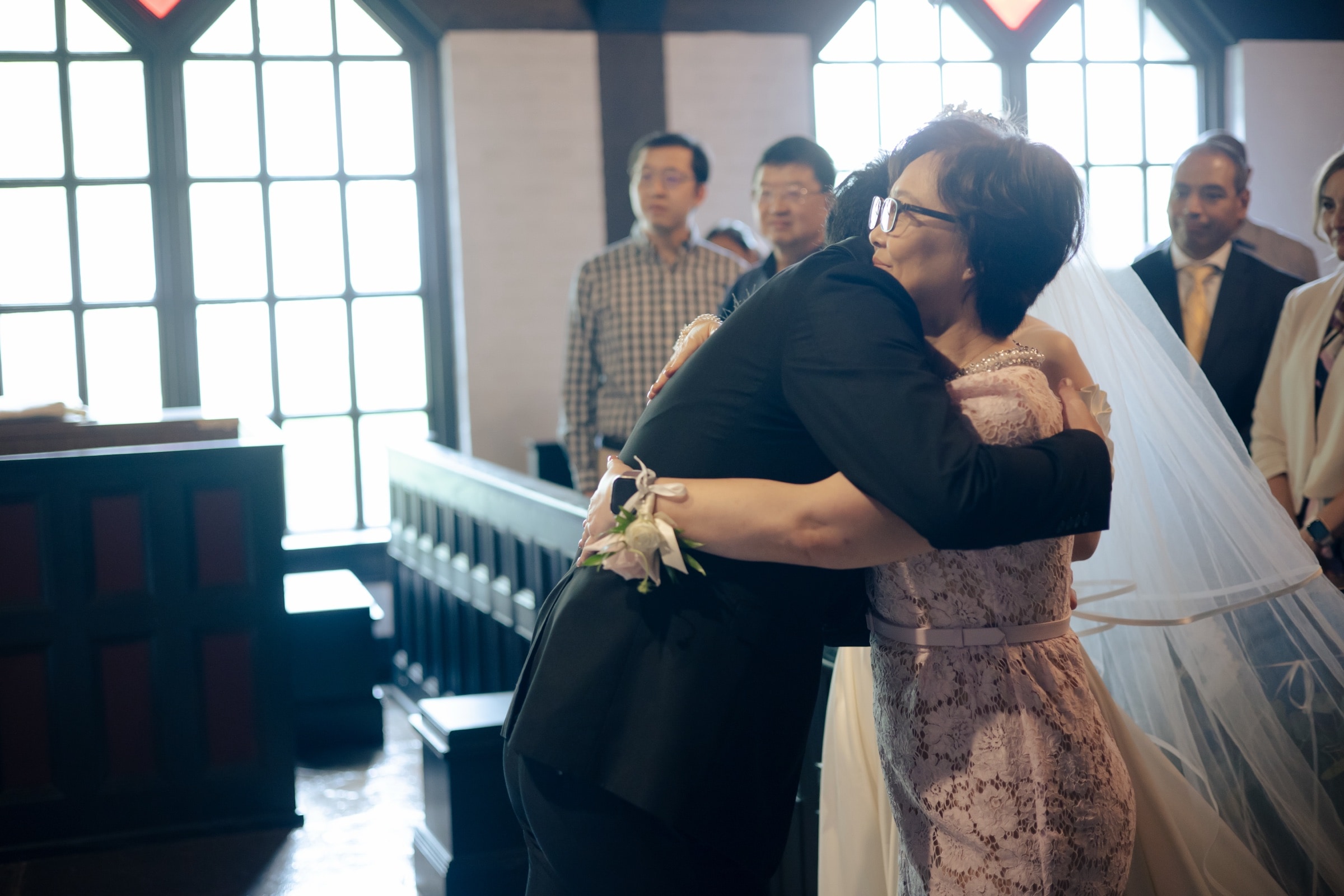 Black-and-white portrait of the couple in a closing embrace