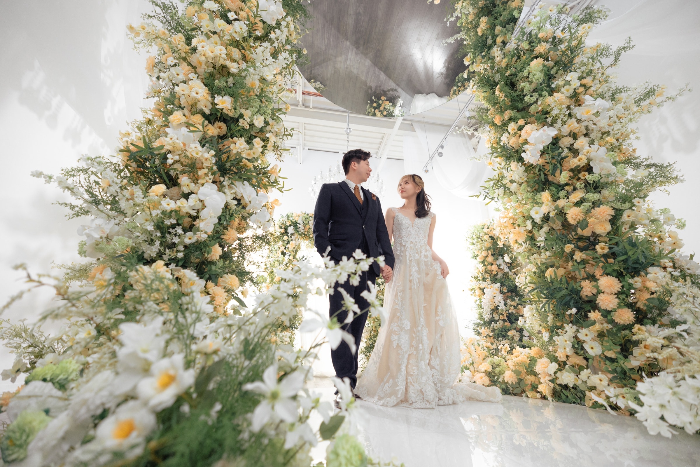 The couple at the floral arch