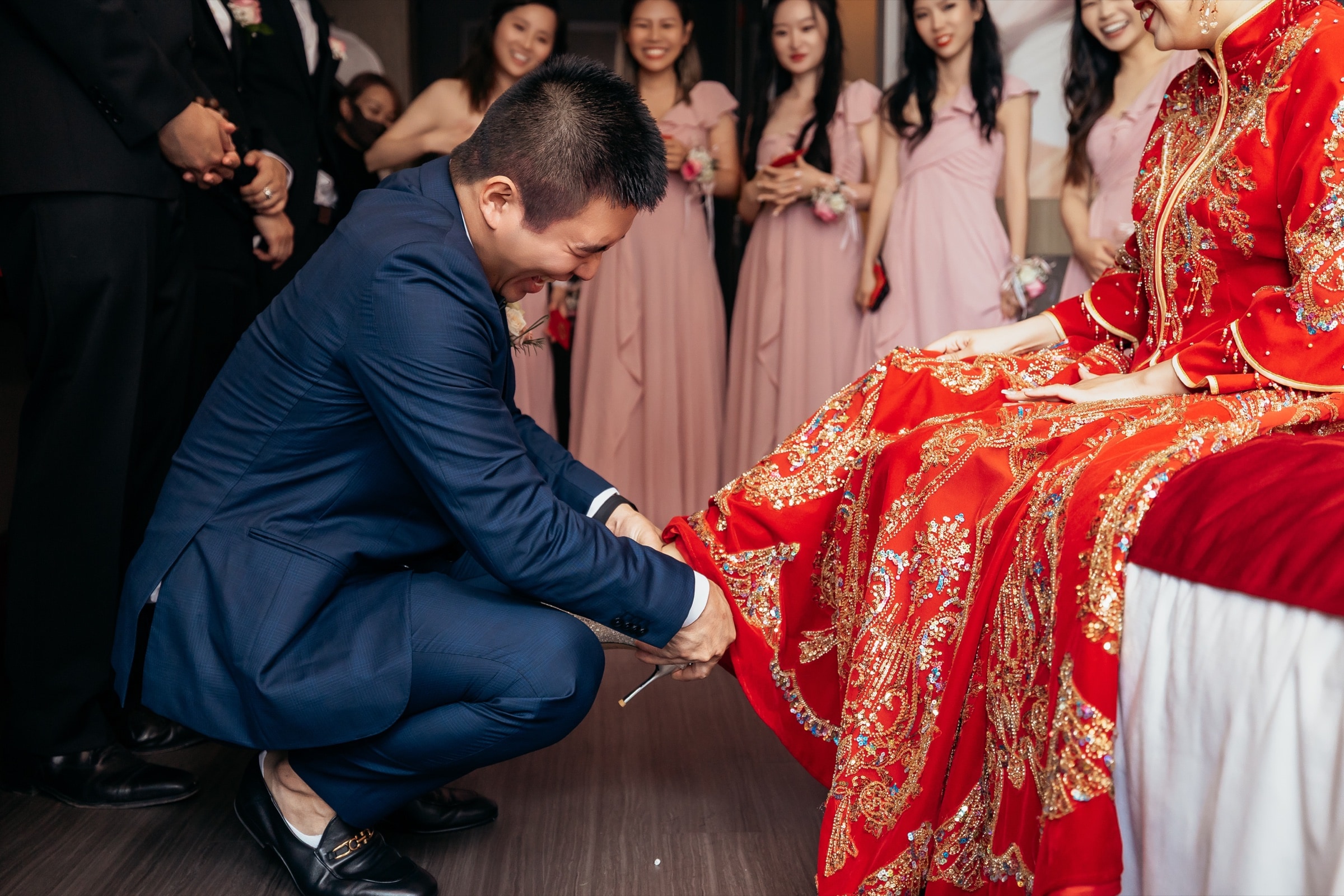 The groom kneeling during the bride pick-up ritual