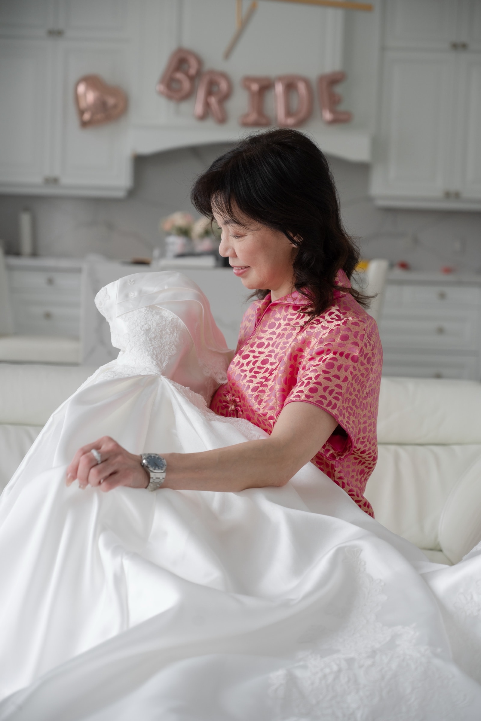 Final touches to the bridal gown during getting ready