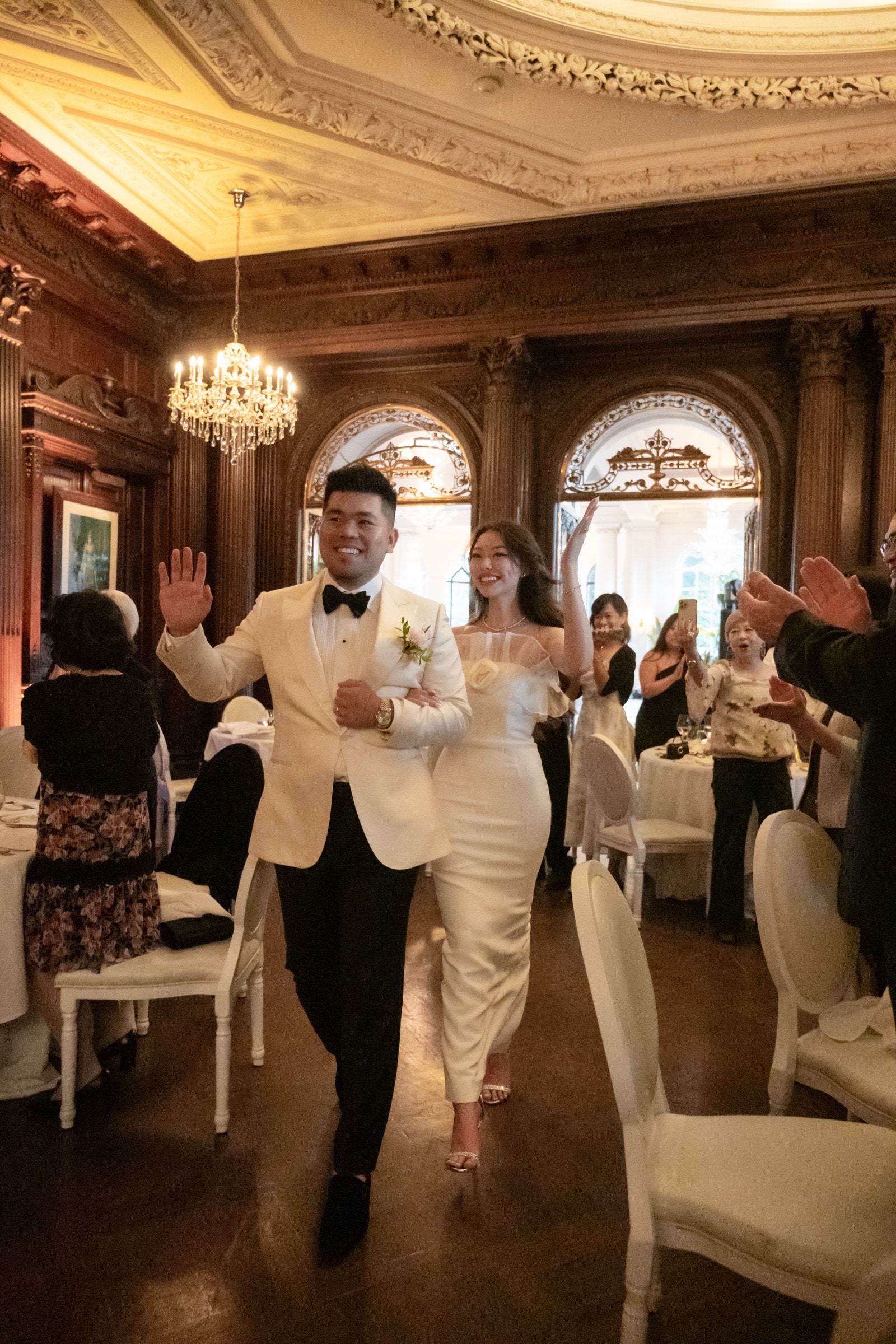 The newlyweds entering the reception to cheering guests