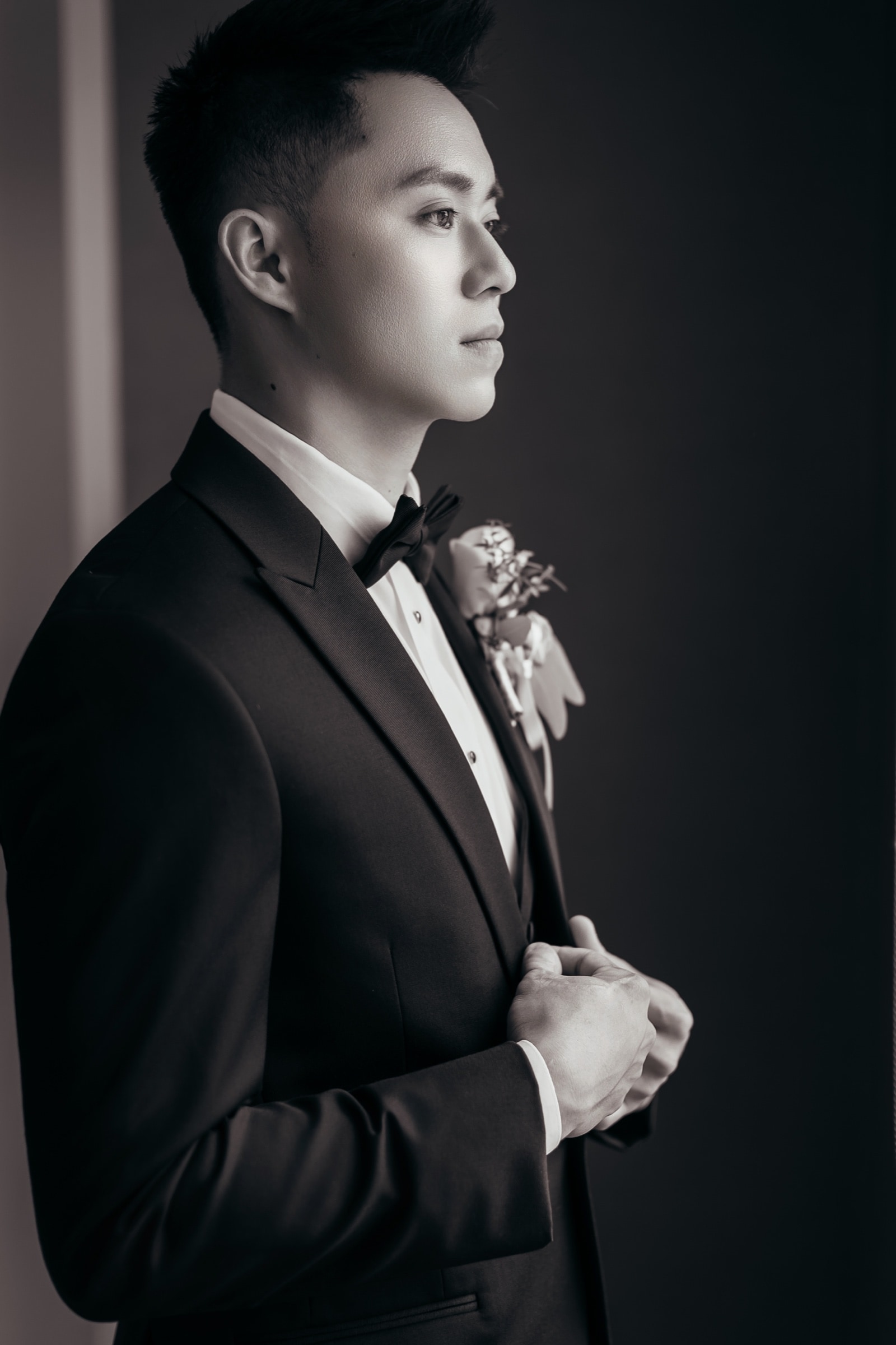 The groom adjusting his bow tie