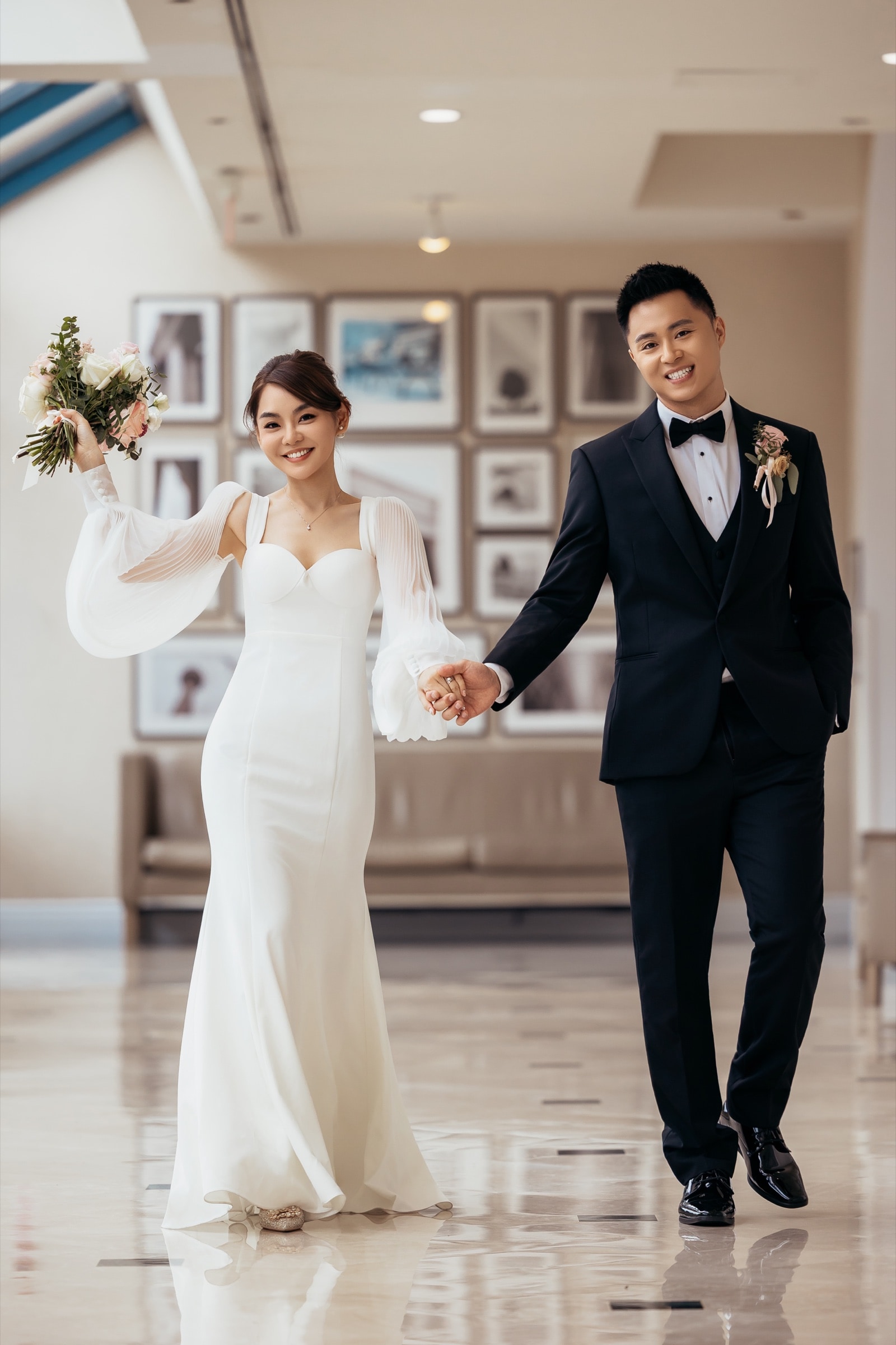 The couple at a wall of blush florals