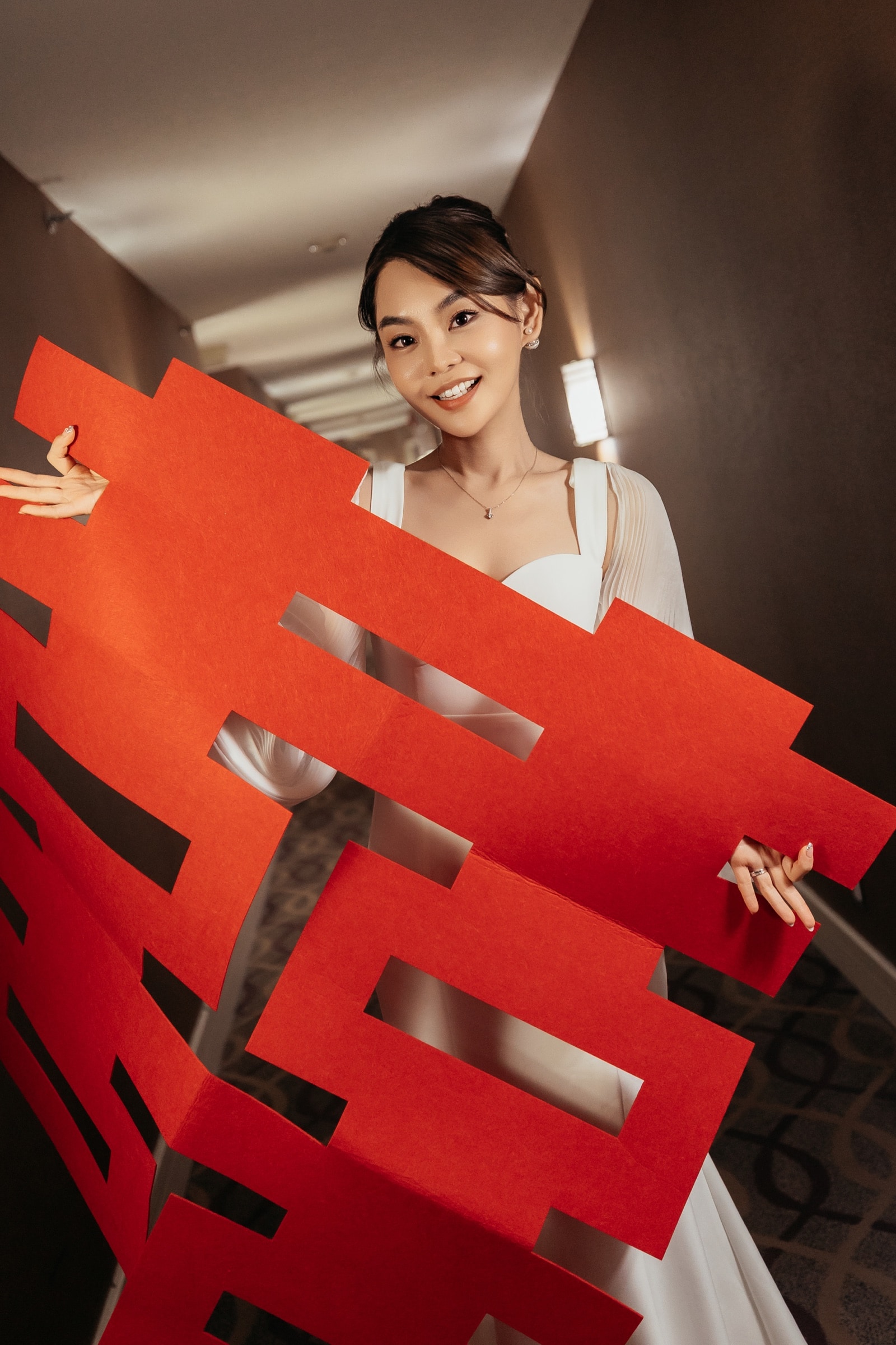 A red double-happiness backdrop at the reception