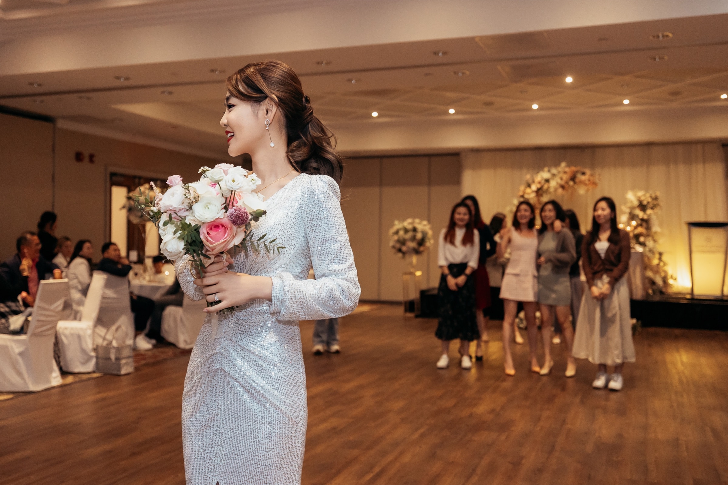 Bride and groom dancing among guests