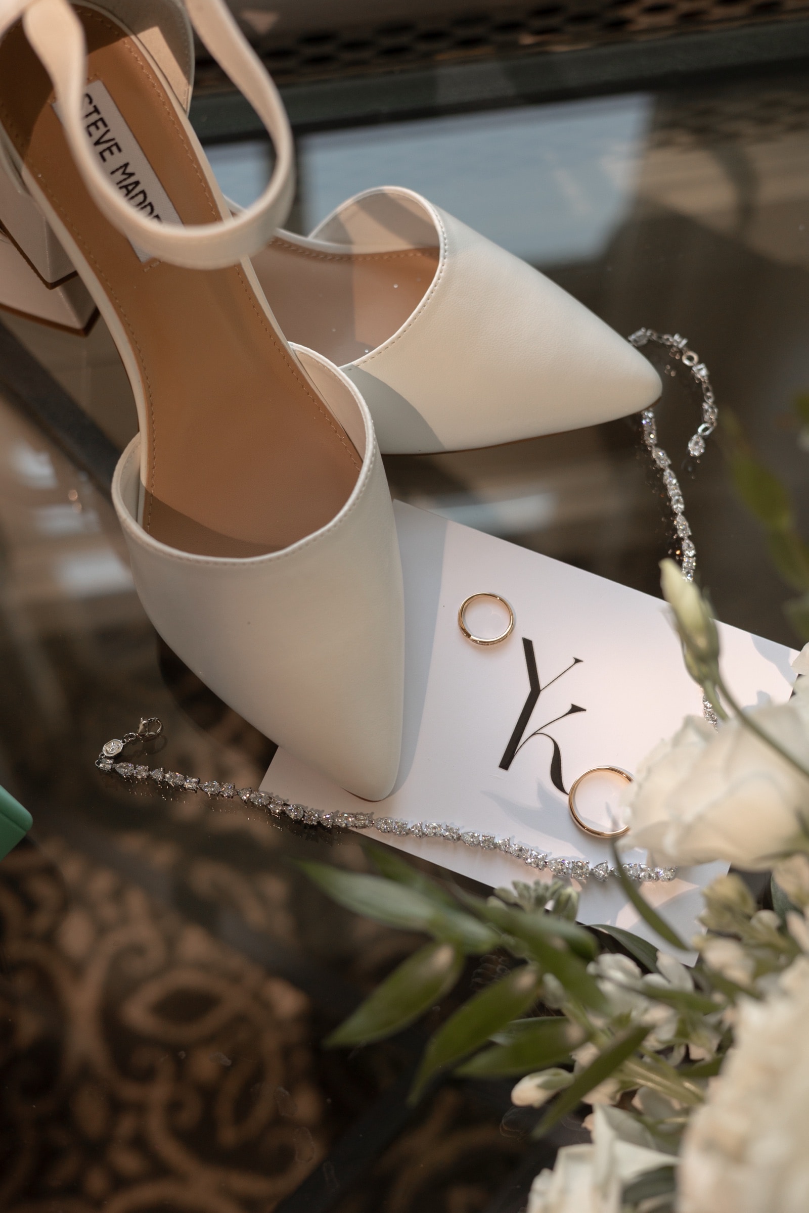 The wedding rings and bridal shoes with a monogrammed card