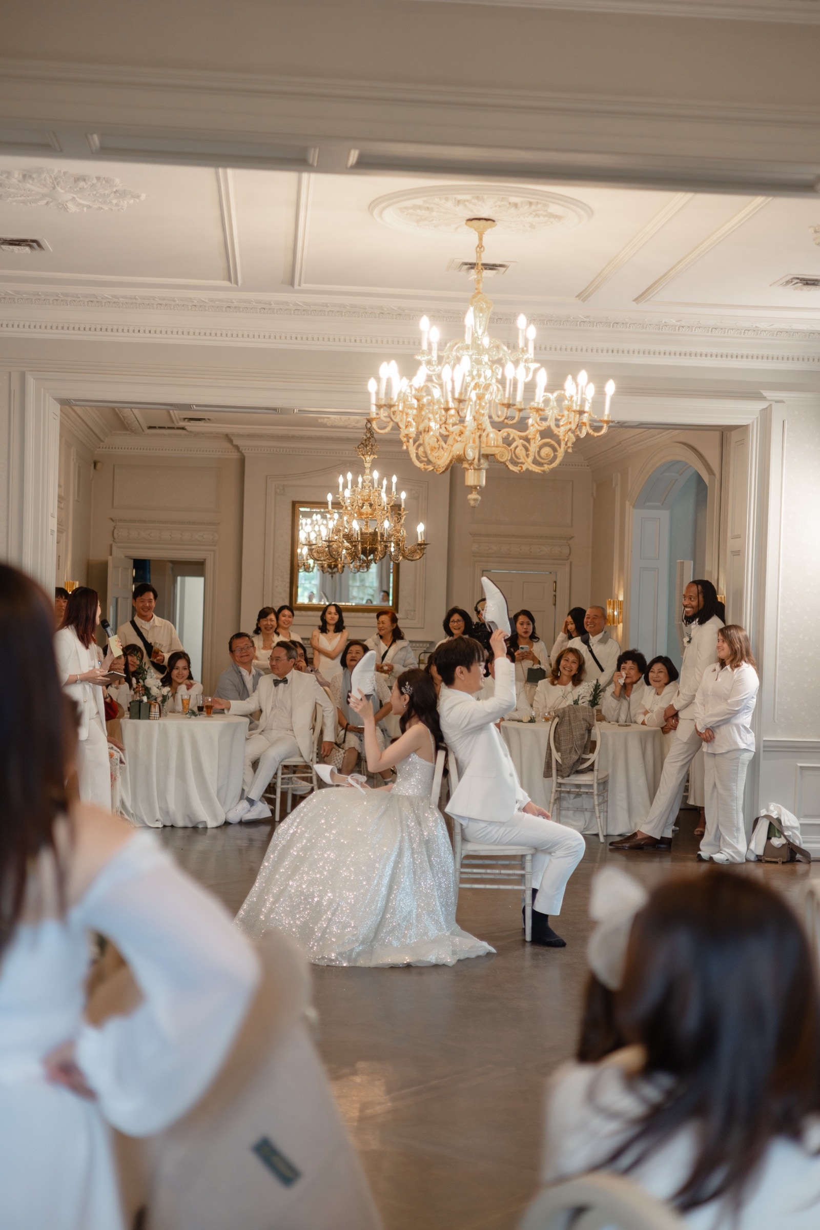 The chandelier-lit reception in an elegant ballroom