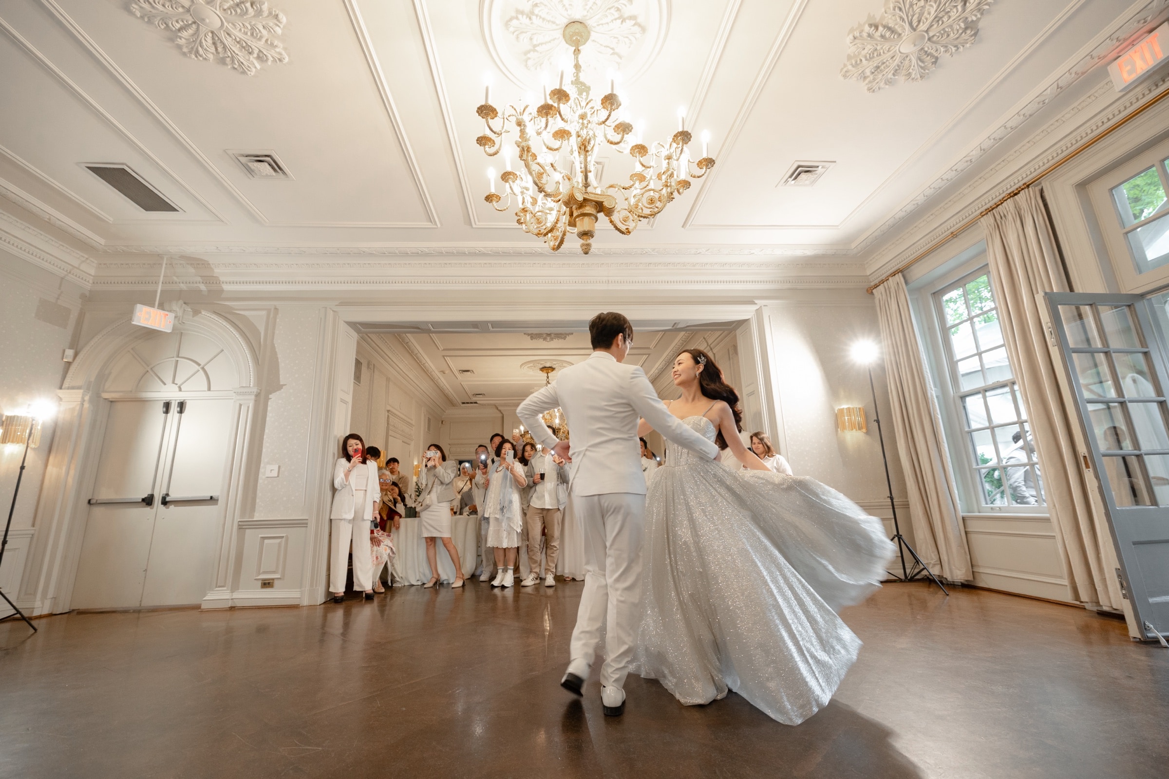 The couple's first dance under the ballroom chandeliers