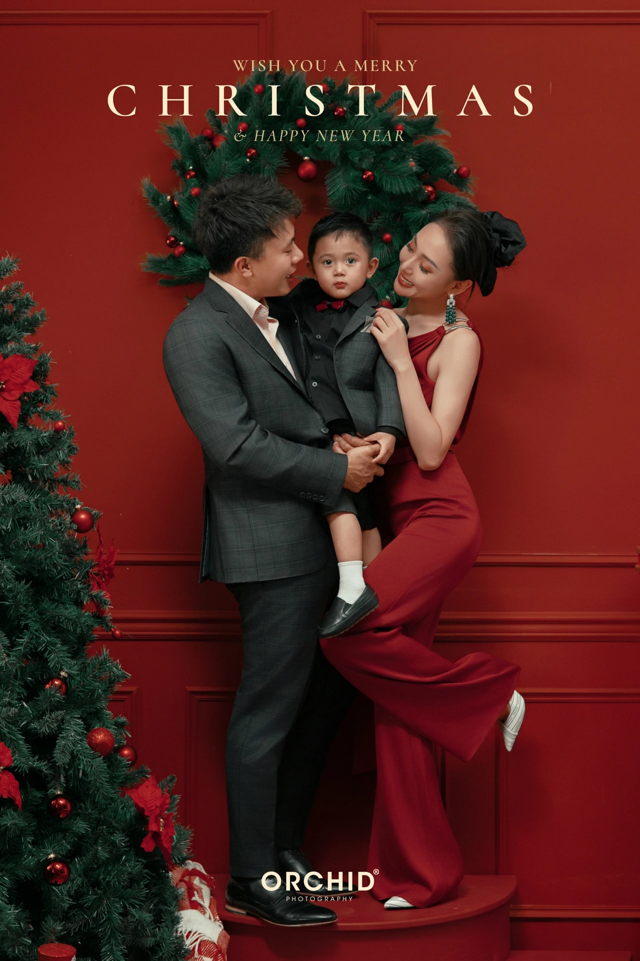 Christmas Wonder — a family by the red wall and the mailbox