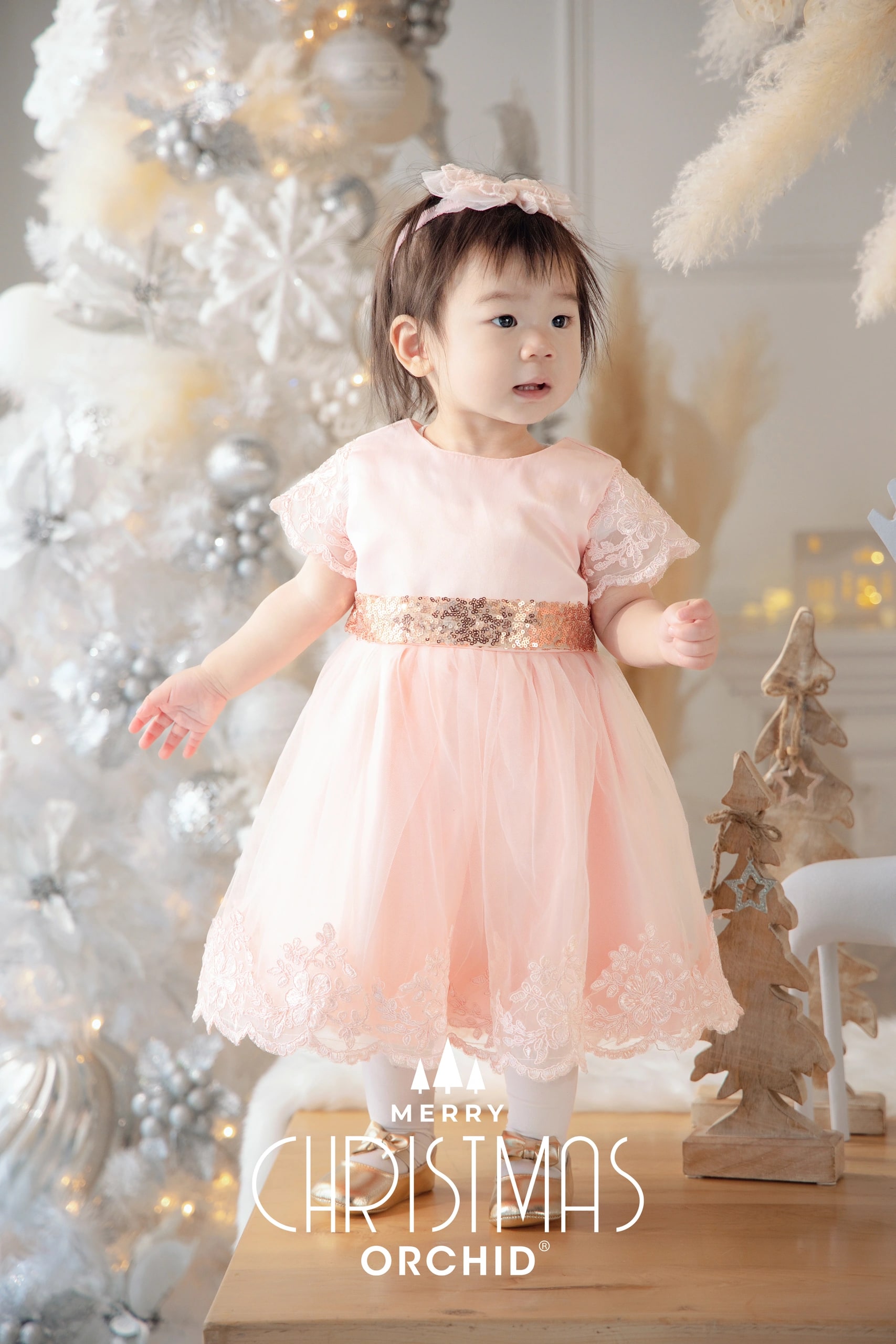 Winter Whispers — sisters in pink dresses with their family