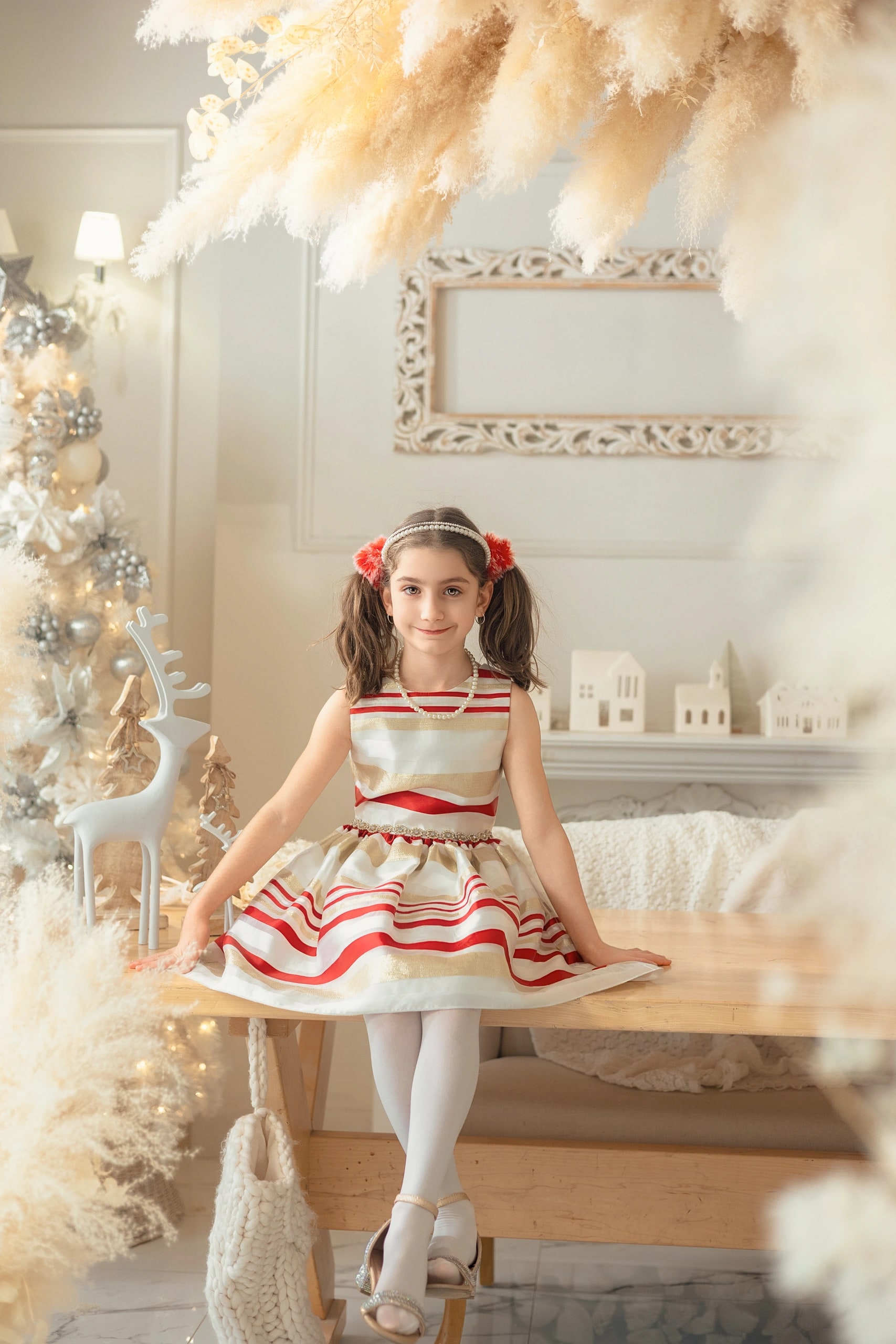 Winter Whispers — a girl in a red-and-white striped dress with her family