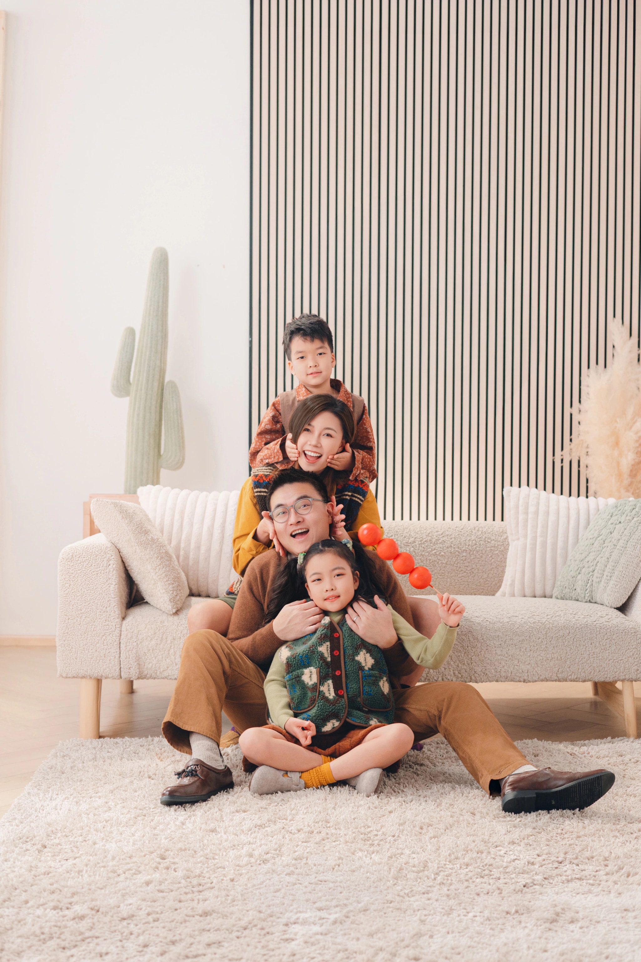 A family with their children gathered together on a sofa